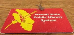 Red library card with a gecko on top