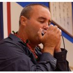 Danilo Marrone playing the harmonica.