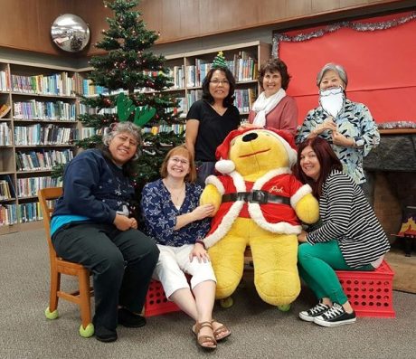 Holiday photo with Winnie the Pooh Santa stuffed animal