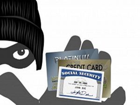 masked character holding credit cards and social security card