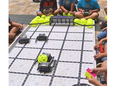 Children playing robotics soccer