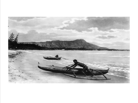 two canoes coming on shore overlooking Diamond Head