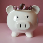 Piggy bank with crown jewels on it's head