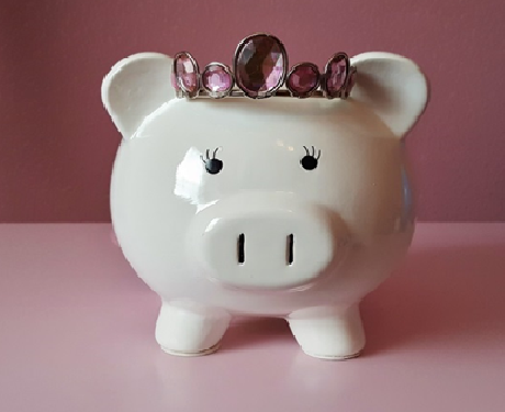 Piggy bank with crown jewels on it's head