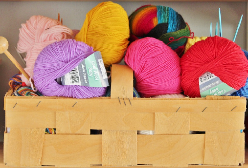 a container of different color yarn