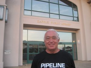 Man smiling in front of building