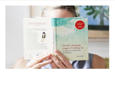 Female reading The Life Changing Magic of Tidying Up book