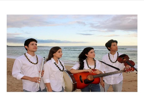 Four members of the Welch family holding instruments and standing on beach