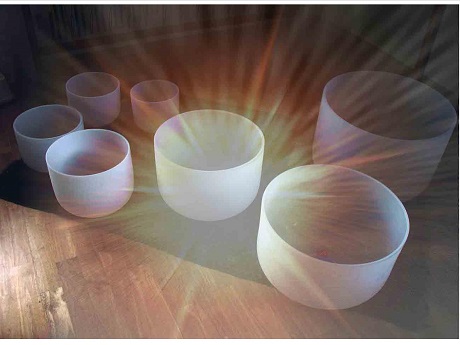 7 Crystal Singing Bowls with sun burst light shining in the center