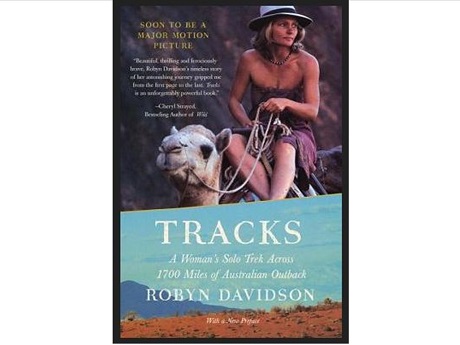 Book cover with Robyn Davidson riding one of her camels with title superimposed over the Australian outback