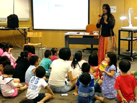 Anamika telling a story to a group of children.