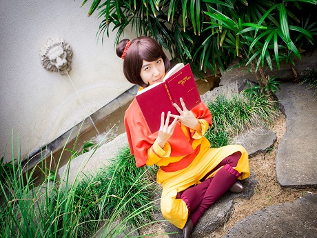 Woman in a costume reading a book
