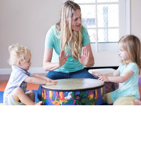 Mom and two children playing a drum