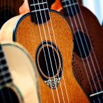 Three ukuleles of differing wood colors