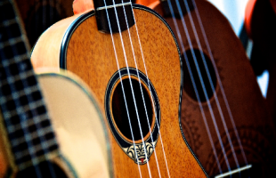 Three ukuleles of differing wood colors