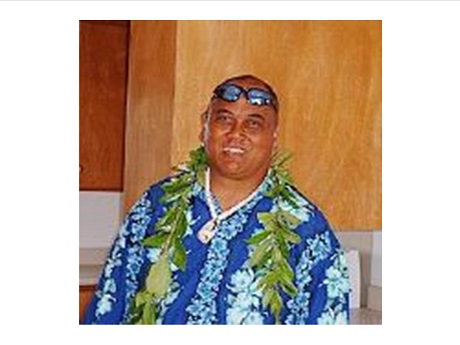 Man wearing aloha shirt and lei
