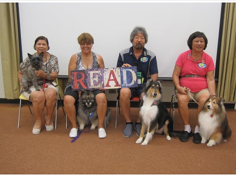 4 people each holding a dog