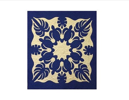 quilt blue and gold design, looks like palm trees, turtles, and leaves in the design like a squarish snowflake