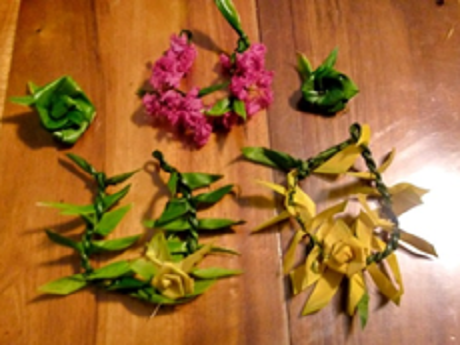 Three ti leaf bracelets and two ti leaf rosettes.