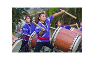 Three women drumming