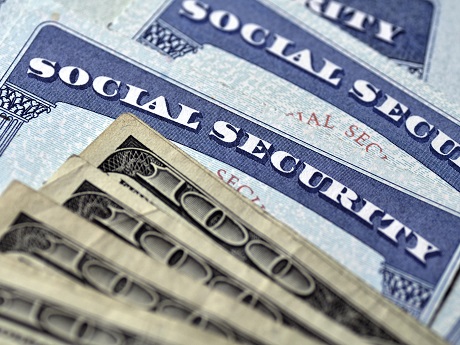 Social Security cards with several hundred dollar bills