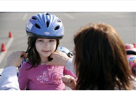 Little Girl with Female Adult Helping to Adjust Bike Helmet