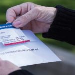 Woman holding Medicare ID card in her hands
