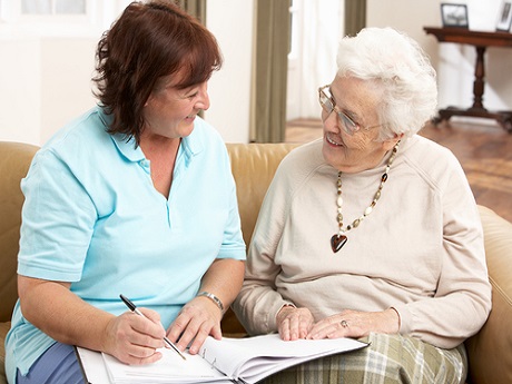 woman assisting senior making decisions