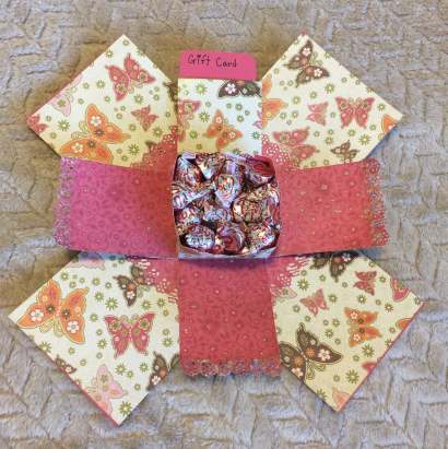 pink and cream open gift box with butterfly accents