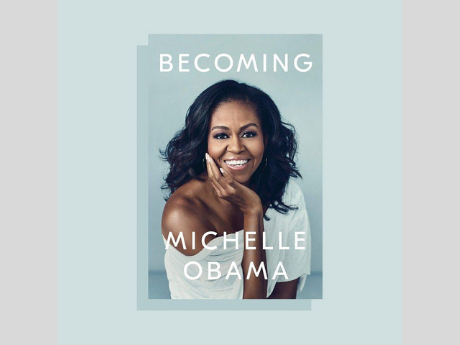 Cover art of the book Becoming, featuring a photograph of the author, Michelle Obama, smiling.