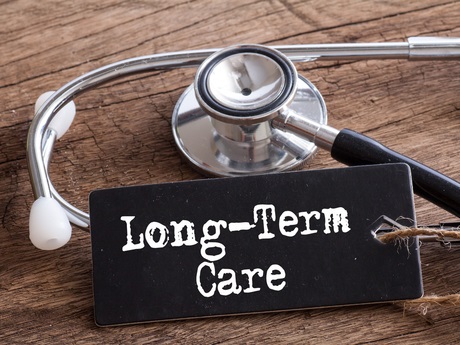 Long term care sign with stethoscope on a table