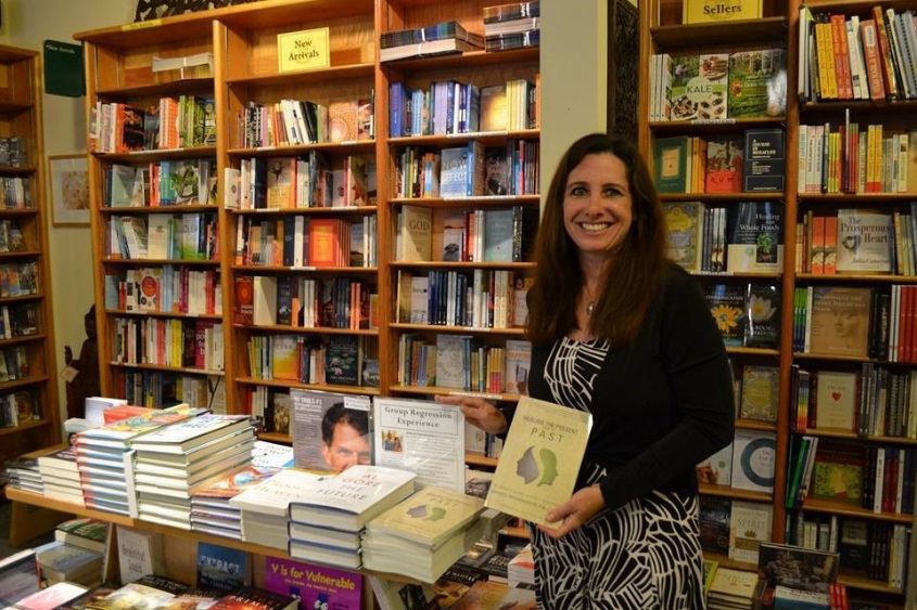 Heather Rivera holding her book at a bookstore