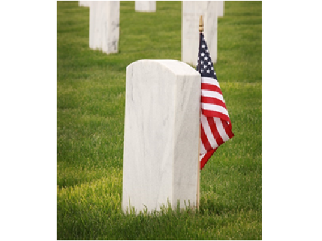 memorial day tombstone with a flag by it