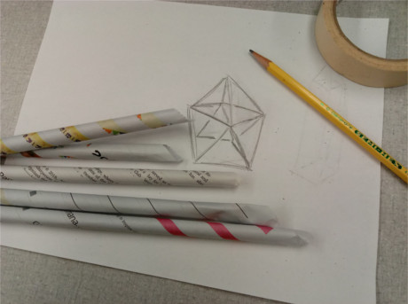 A drawing of a space structure, newspaper sticks, pencil, and tape