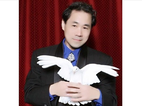 Magician James Lee holding a dove