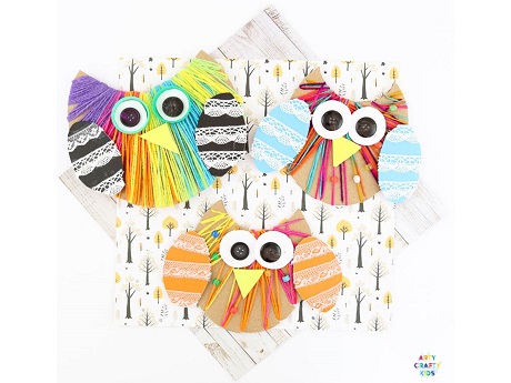 Colorful owls made from yarn and cardboard