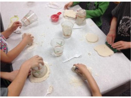 children's hand playing with dough