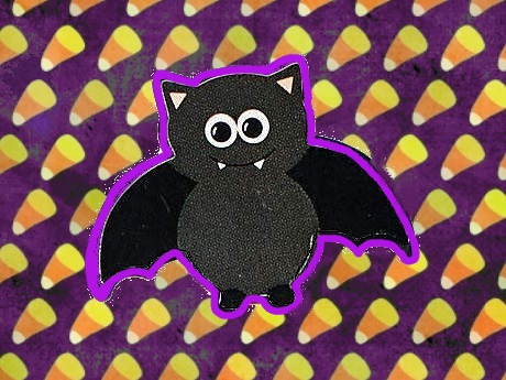 black bat sticker on candy corn background