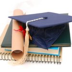 Graduation cap, diploma and notebook