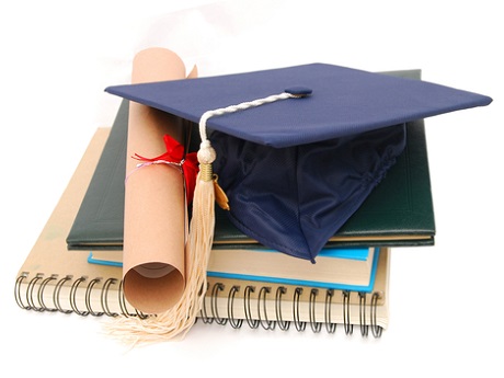 Graduation cap, diploma and notebook