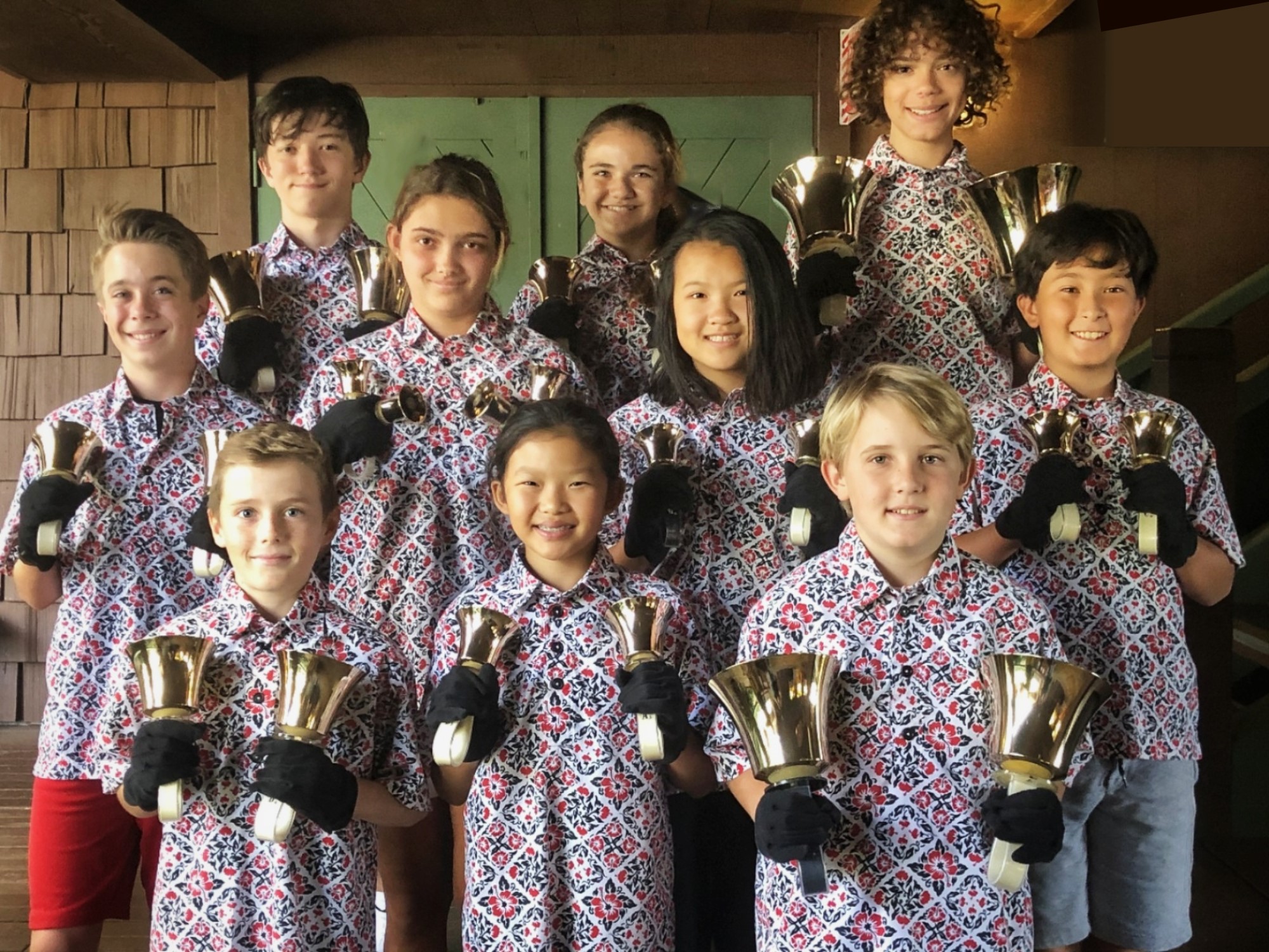 Children from Hawaii Preparatory Academy Middle School Handbell choir holding handbells