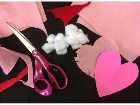 Felt and Paper Hearts with Cotton Balls and Scissors on Black Background
