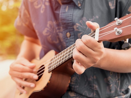 Male playing an ukulele