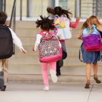 Young children running to school