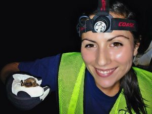 USGS biologist Kristina Montoya-Aiona holding Hawaiian Hoary Bat