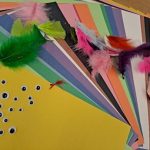A rainbow of construction paper, googly eyes, colored feathers