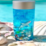 A plastic bottle filled with blue dye, glitter, and toy sea creatures