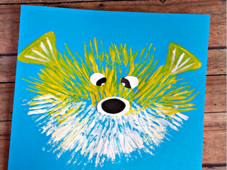 Painting of a yellow and white pufferfish on a blue background