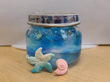 Jar with blue water beads and shell shapes