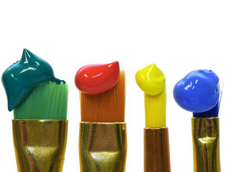 green, orange, yellow and blue paint brushes with paint drops on them